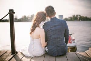 Couples sitting along beach side